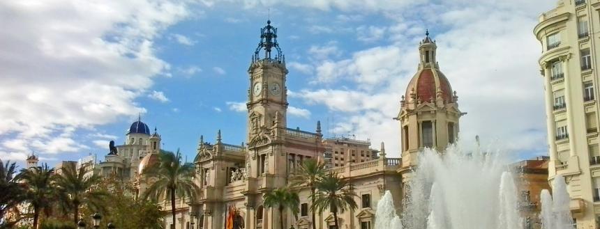 Plaza Ayuntamiento in Valencia with a fountain and clock tower