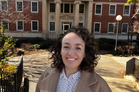 María smiles in front of Gilbert Hall