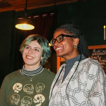 Two women smile at the camera