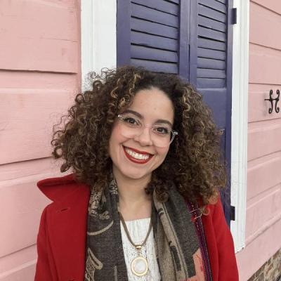 Curly hair woman smiling.